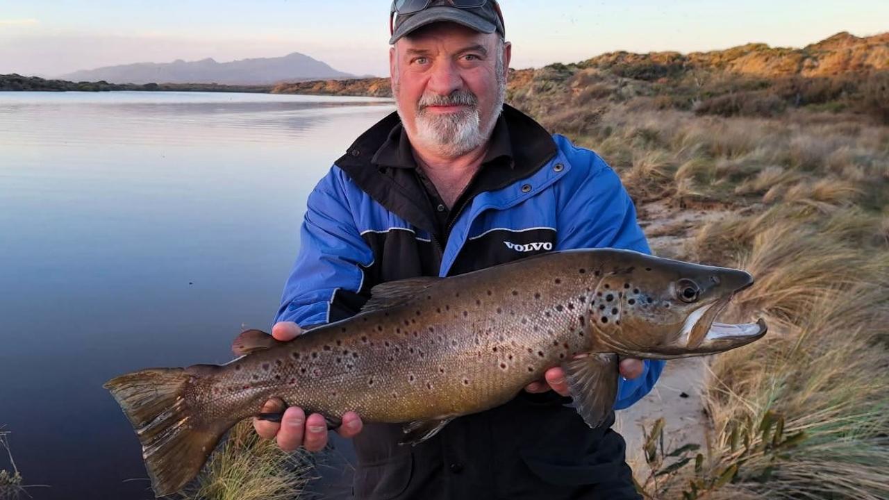 John Burke with a great male brown trout caught from the Henty River