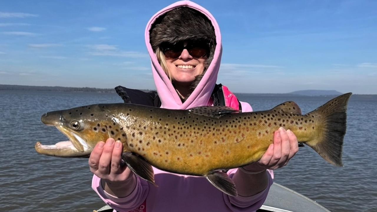 Katie Russell with a solid male brown trout she caught at Lake Sorell