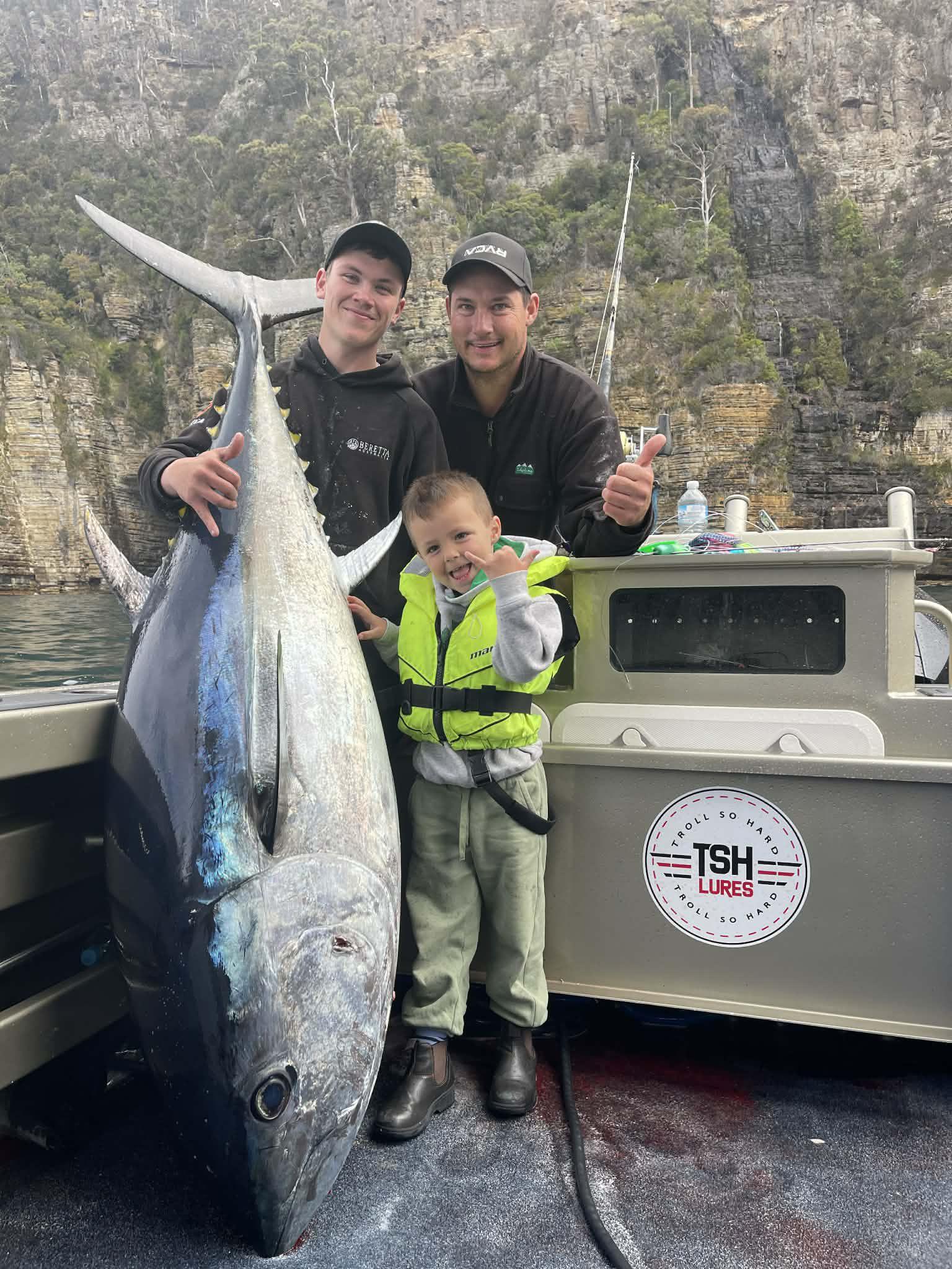Archie & 4 yr Vinnie Cashion with Ajay Cox, far left, after catching an 111kg bluefin tuna