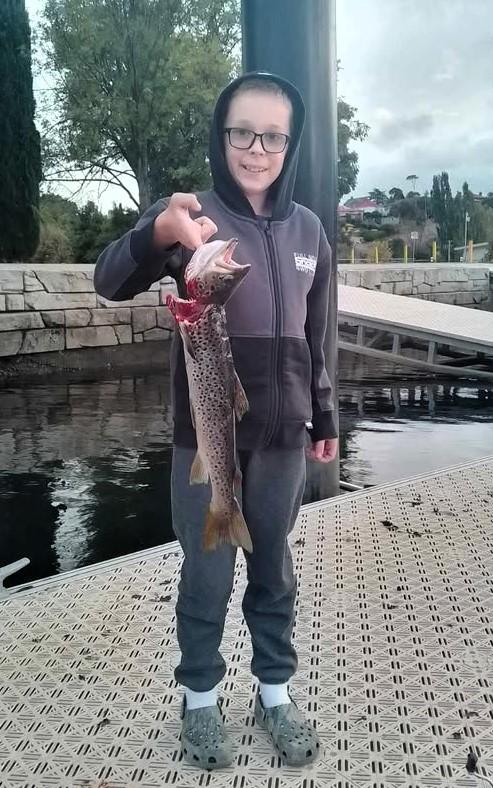 Heath Graham with a nice brown trout he caught on a Tassie Devil from the Derwent River recently.