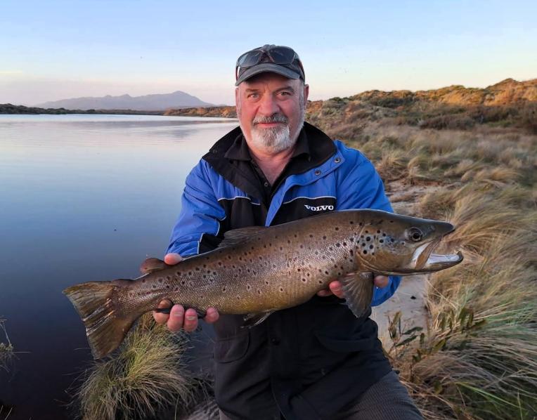 John Burke with a great male brown trout caught from the Henty River