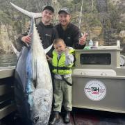 Archie & 4 yr Vinnie Cashion with Ajay Cox, far left, after catching an 111kg bluefin tuna