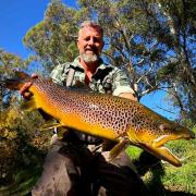 Ben Hoggins and the 6kg male brown trout he caught from the Tyenna River recently