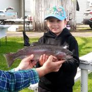 Hunter Raspin holding his winning 1.3 kg rainbow trout 