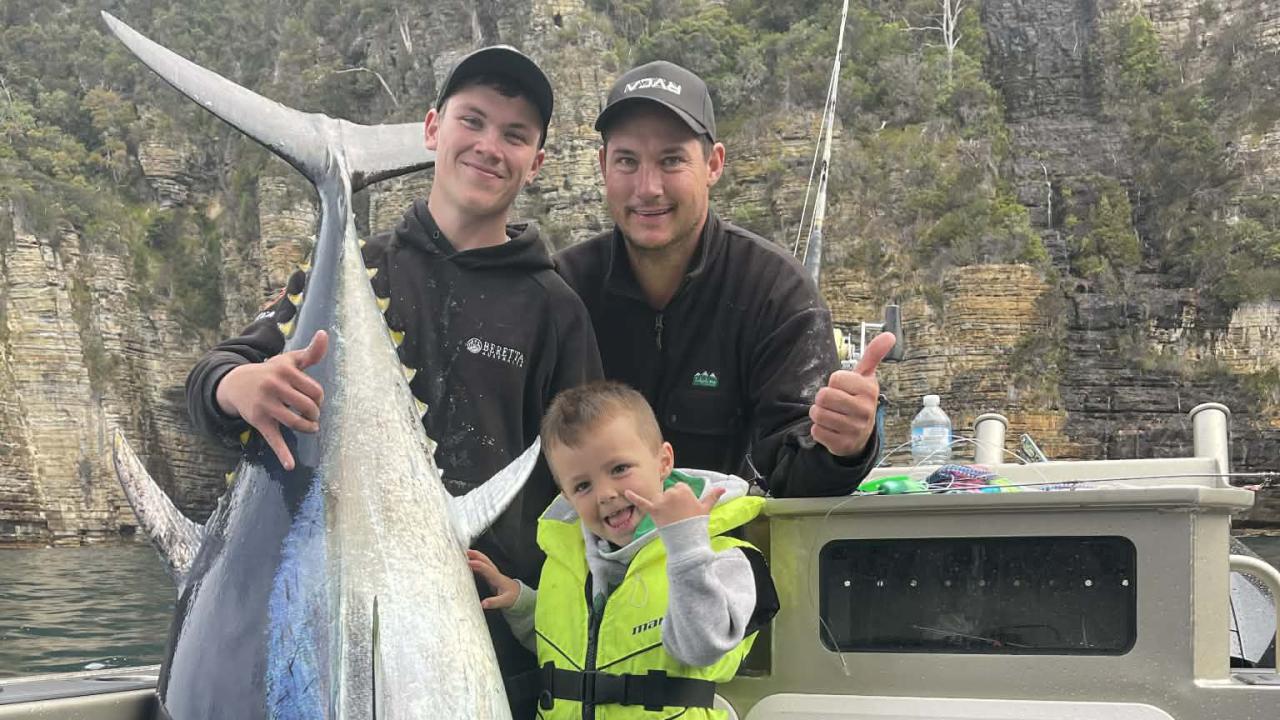 Archie & 4 yr Vinnie Cashion with Ajay Cox, far left, after catching an 111kg bluefin tuna