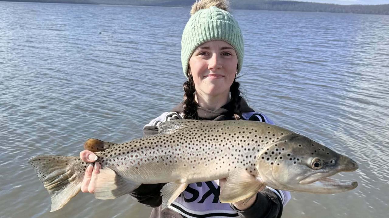 Ebony Forster with a solid male brown trout she caught from Lake Crescent recently