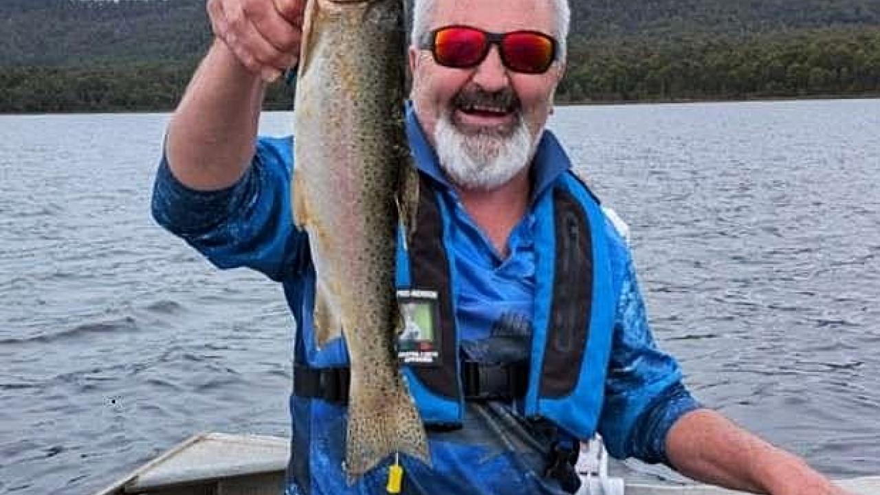 Wayne Colling with the tagged trout he caught