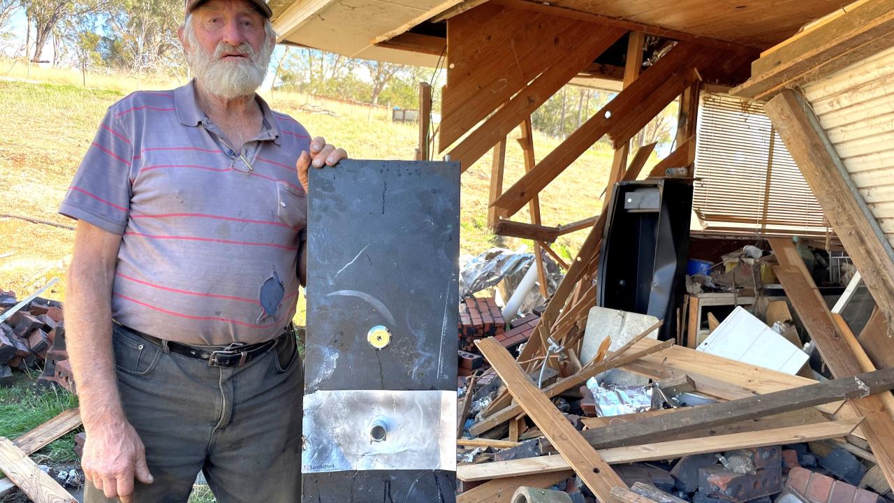 Whitemore sheep farmer David Lindsay with the door of his gun safe (in the background) that was prised off when thieves destroyed his garage and stole his rifle.