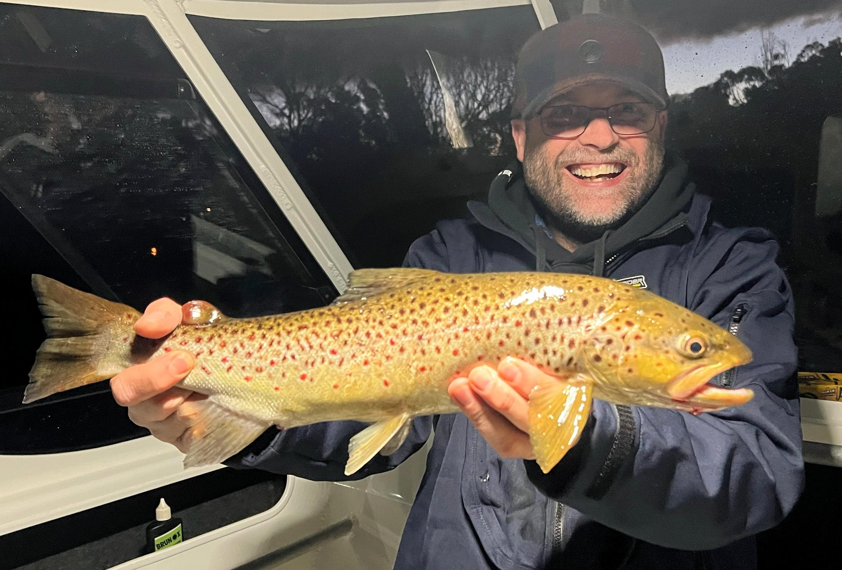 Adam Williams with a trout caught recently in the Derwent River.