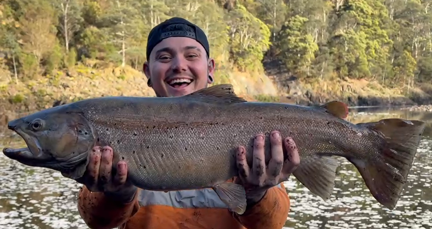 Kade Wall with the magnificent female brown trout he caught and released in the Pieman River.