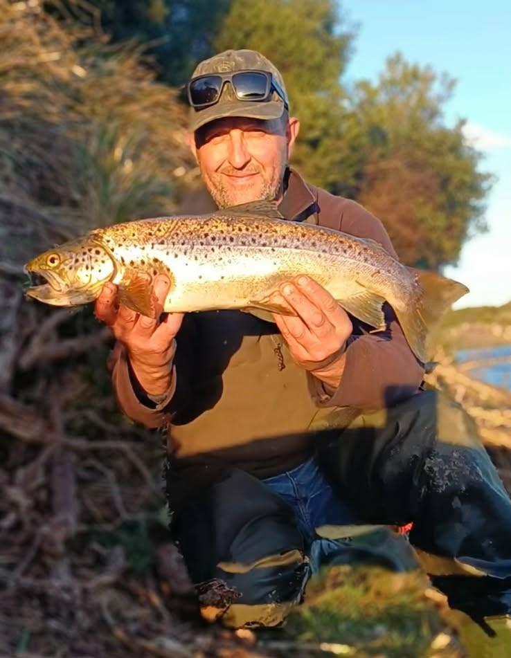 Adrian Slater with a solid female brown trout he caught from Blackmans Lagoon recently.