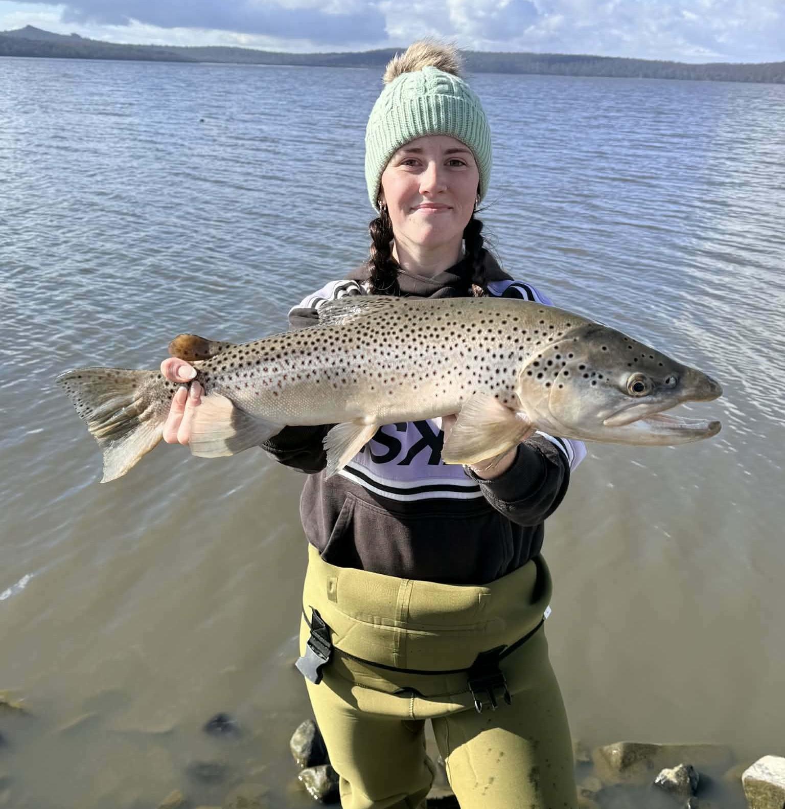 Ebony Forster with a solid male brown trout she caught from Lake Crescent recently