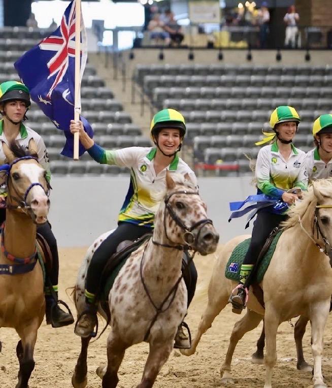 Ruby Atkins leads the Australian team’s victory lap on a one-eyed pinto pony, Woody, who was one of the horses used by teams contesting the 2026 International Mounted Games Exchange title in Kentucky, USA.