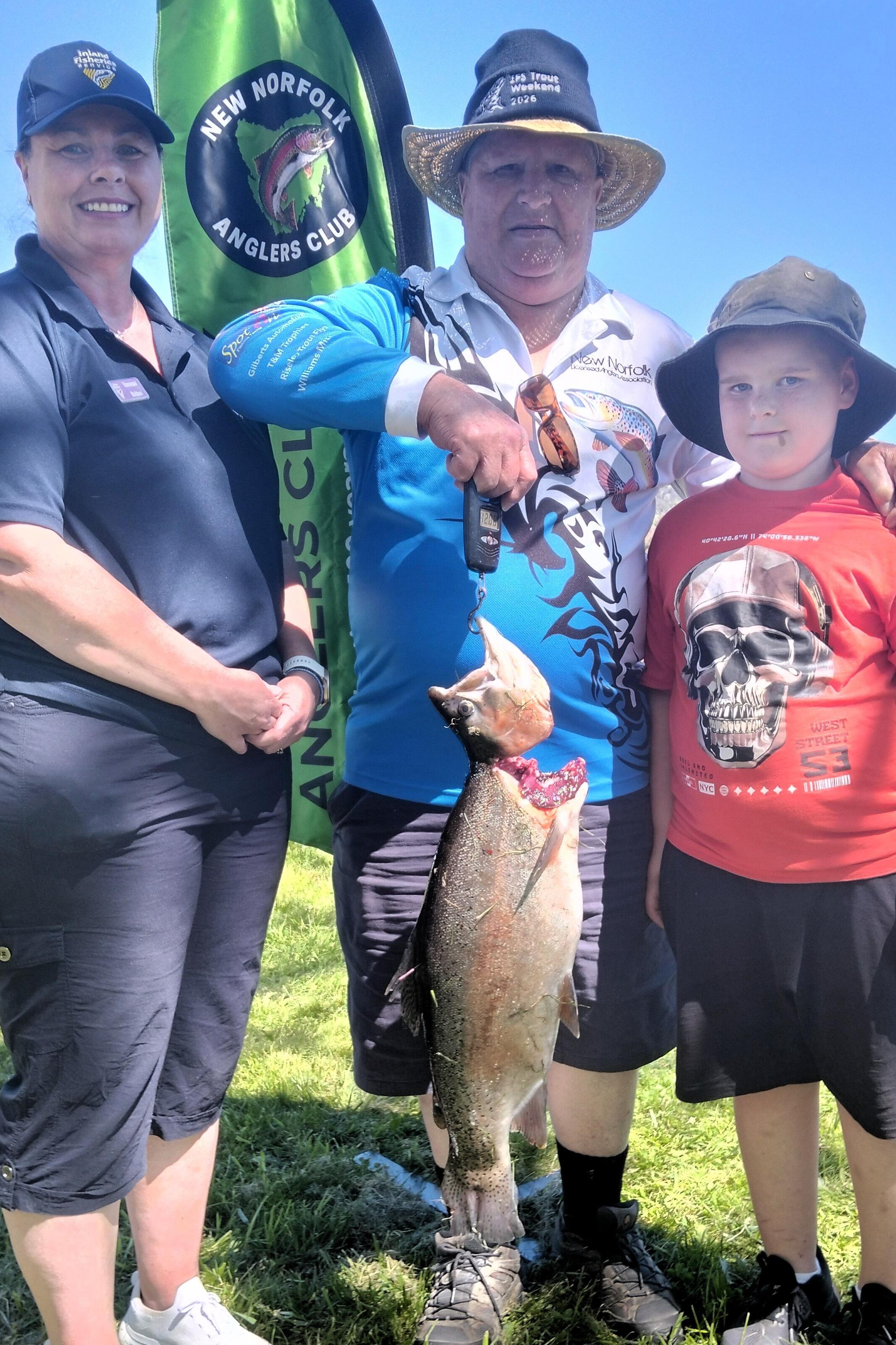 Inland Fisheries Service executive officer Vanessa Britten and NNLAA president Laurie Harrison with nine-year-old Caleb Quarrell and his 5.4kg rainbow trout caught during Sunday's Gone Fishing Day celebrations.