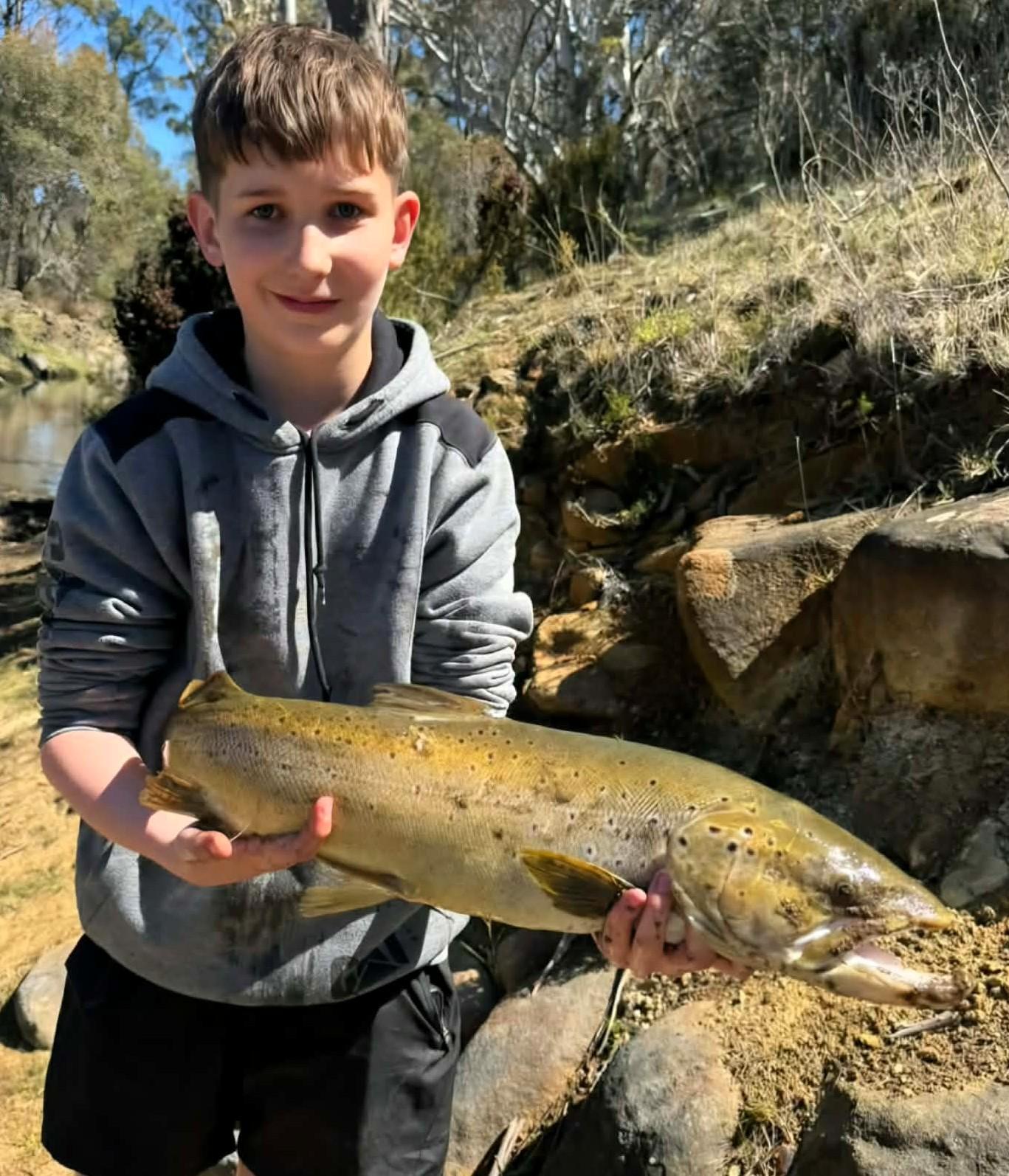 Zeke Rice, 13, with a big brown trout caught recently in the Clyde River. It was only the second trout he has caught.