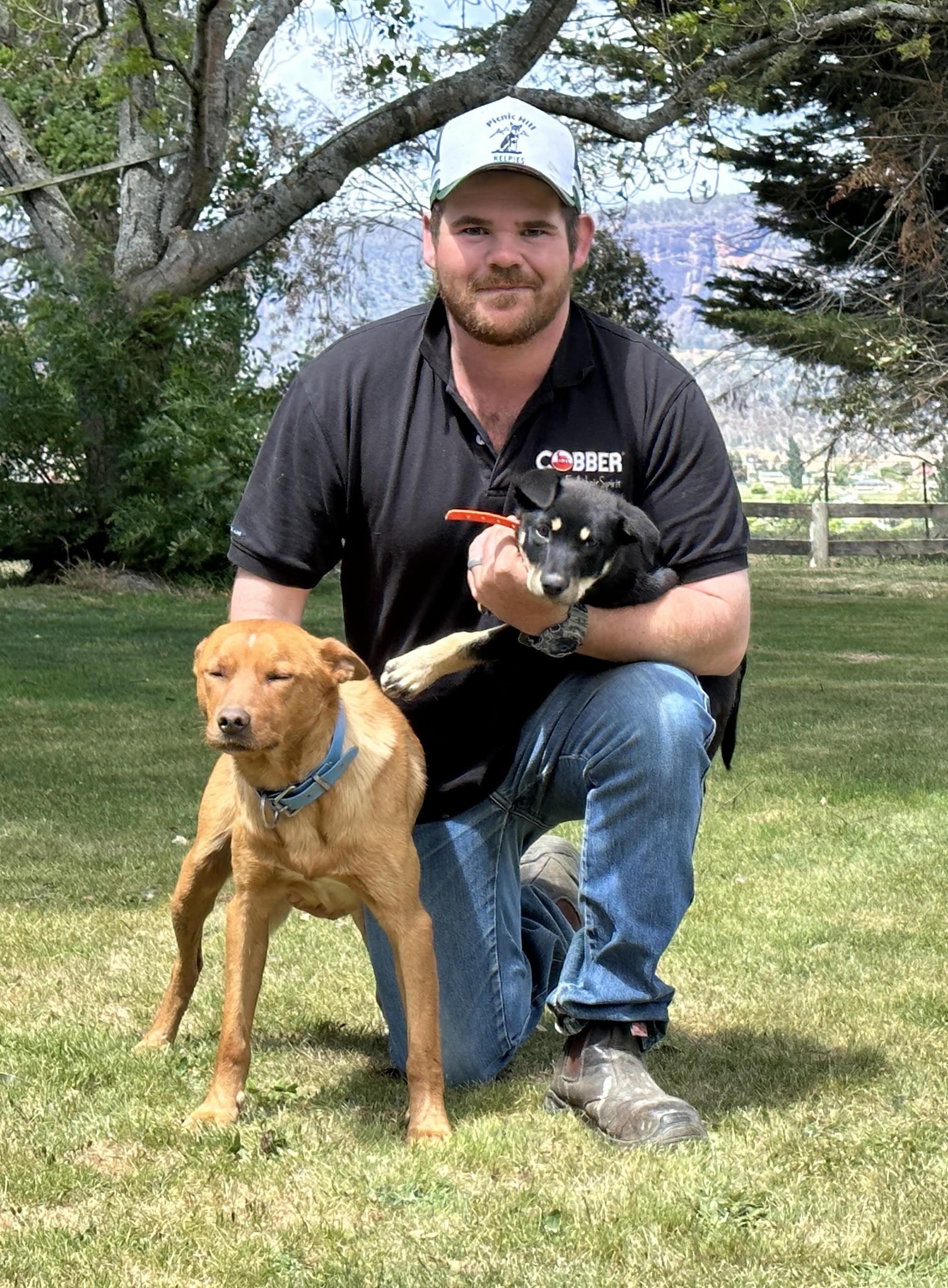 Alex Johns with Cobber Challenge champion Earl and new puppy Joey.