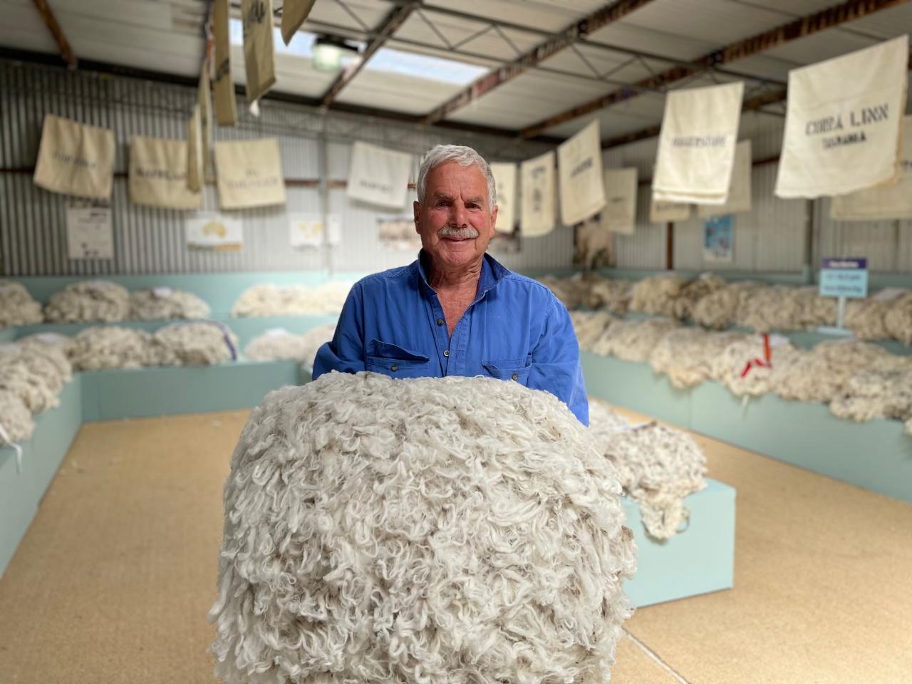 Caption: Longford Show Fleece Steward Jim Young with one of the fine Merino fleeces which was among 128 entries from 51 sheep properties around the state.