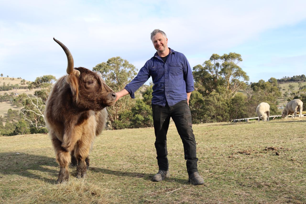 William the highland cow with Eventide Sanctuary owner Ian Womack