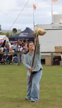  Alice Holloway of Launceston has a go at sheaf tossing.