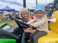  Rosemary Humphries of Launceston with her granddaughter Helena, 3, testing out a small tractor.