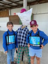 Grace Whelan of Dilston and Joe Archer of Dilston with Joe's scarecrow project.