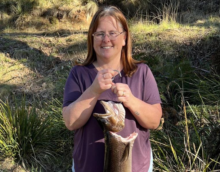 Kylie Price with the 2.9 kg or 6.6 lb brown trout she caught from the Huon River.
