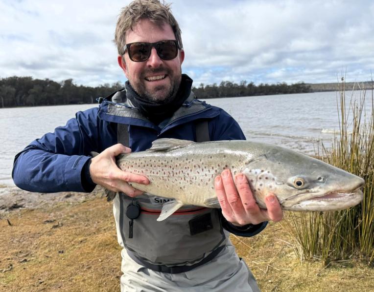 Peter Bradnam with a solid male brown trout he landed and then released after a big fight from the shore at Lake Crescent recently