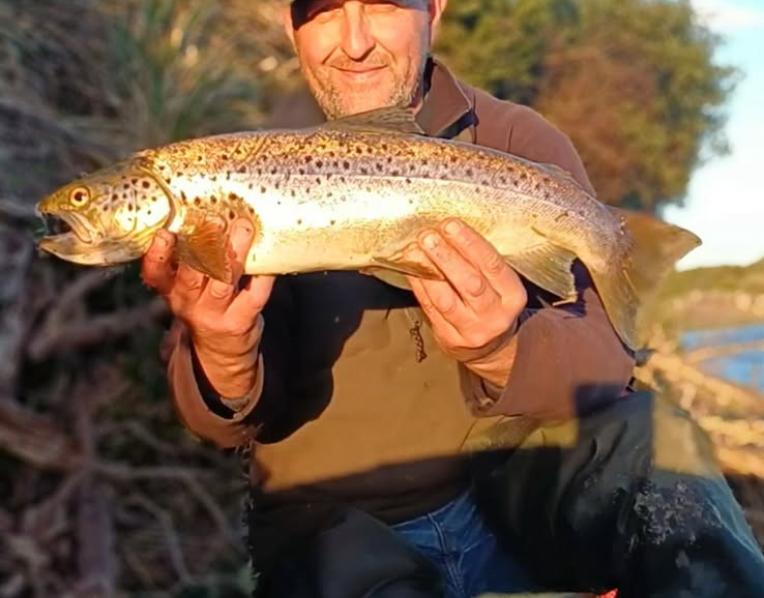 Adrian Slater with a solid female brown trout he caught from Blackmans Lagoon recently.