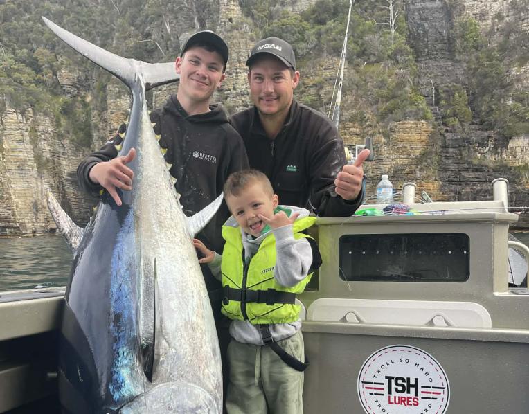 Archie & 4 yr Vinnie Cashion with Ajay Cox, far left, after catching an 111kg bluefin tuna