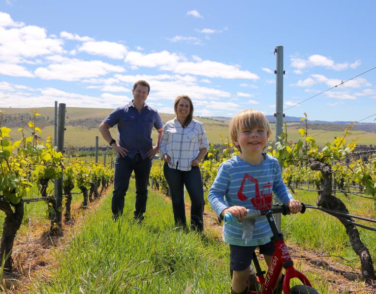 Alex Dean and Mardi with their son, Lewis, in the vines at Meadowbank Wines.