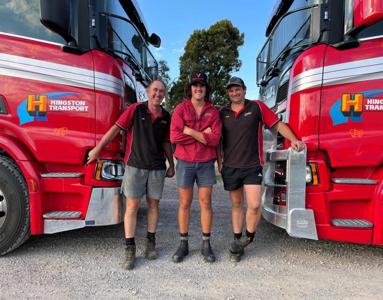 Nick Hingston and son Xavier and truck driver Justin House with two Scania livestock trucks