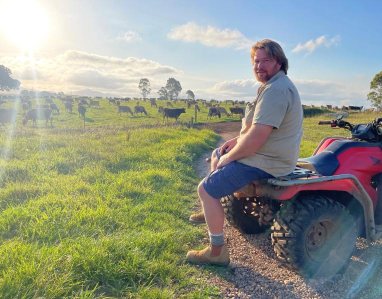 Mark Lambert looking over his organic dairy farm at Sunnyside