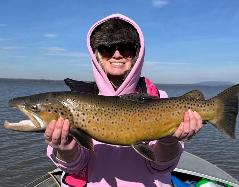Katie Russell with a solid male brown trout she caught at Lake Sorell