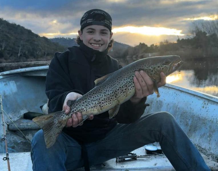 Mitchell Kaititis with a solid brown trout he caught from the Derwent River recently