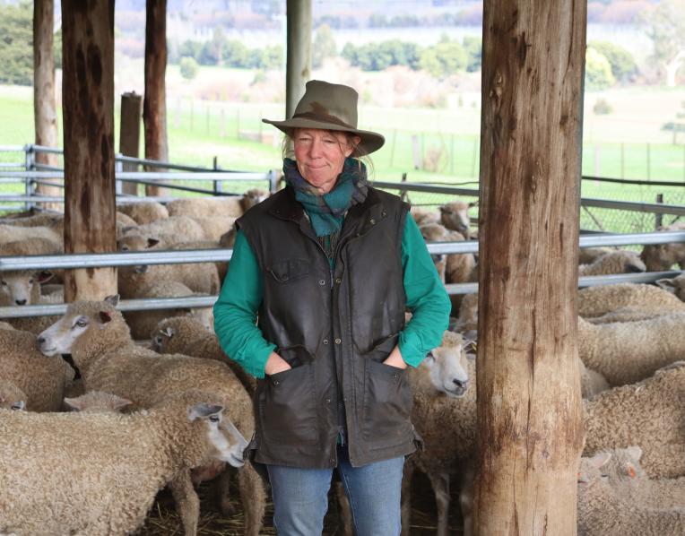 Fiona Hume surrounded by sheep