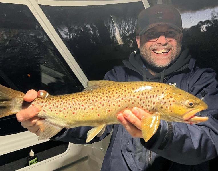 Adam Williams with a trout caught recently in the Derwent River.