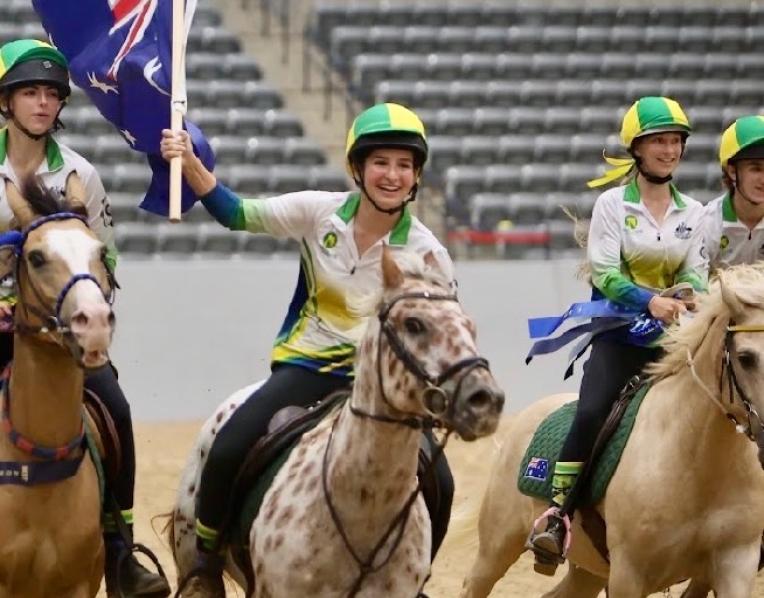 Ruby Atkins leads the Australian team’s victory lap on a one-eyed pinto pony, Woody, who was one of the horses used by teams contesting the 2026 International Mounted Games Exchange title in Kentucky, USA.