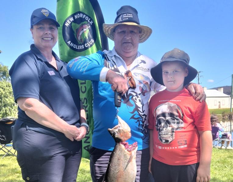 Inland Fisheries Service executive officer Vanessa Britten and NNLAA president Laurie Harrison with nine-year-old Caleb Quarrell and his 5.4kg rainbow trout caught during Sunday's Gone Fishing Day celebrations.