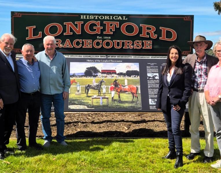 Signage Working Committee member and former racing journalist Peter Staples, Longford racing legend Max Baker, committee member Dennis Pettyfor, Racing Minister Jane Howlett, committee members Neil Tubb and Barb Baker with the new Longford Racecourse signage.