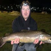 Luke Cass with the big male trout he caught from the lower reaches of the Derwent River last week
