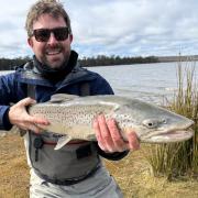 Peter Bradnam with a solid male brown trout he landed and then released after a big fight from the shore at Lake Crescent recently