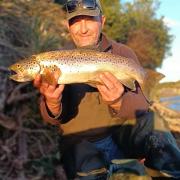 Adrian Slater with a solid female brown trout he caught from Blackmans Lagoon recently.