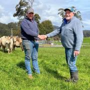 Bernard Atkins hands over his Elbern Murray Gray Stud to Troy Wright.