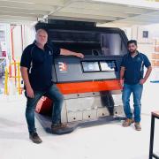 Tasmanian Seed Dressing and Storage general manager Morgan Leath and operations manager Abhi Gupta in front of the 3U Vision Fenix 4