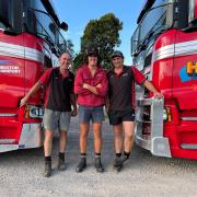 Nick Hingston and son Xavier and truck driver Justin House with two Scania livestock trucks