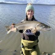 Ebony Forster with a solid male brown trout she caught from Lake Crescent recently