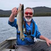 Wayne Colling with the tagged trout he caught