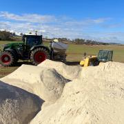 Roger River Dolomite being loaded for application to support soil health and pasture productivity.