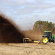 A Wolverine ditcher sends the red soil of Hagley flying