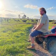 Mark Lambert looking over his organic dairy farm at Sunnyside
